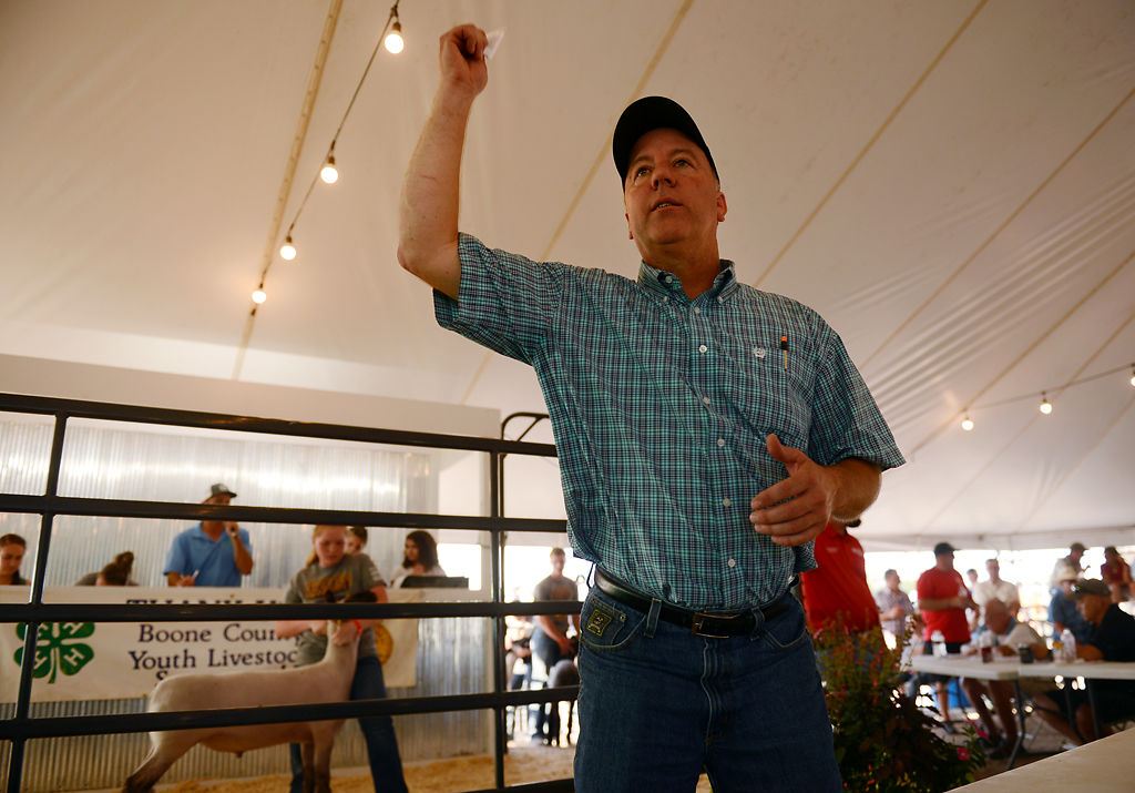 Auctioneer Russ Conklin calls on bids for Bethany Rhoades's sheep RJ